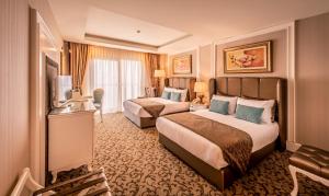 Кровать или кровати в номере Vuni Palace Hotel & Casino & SPA