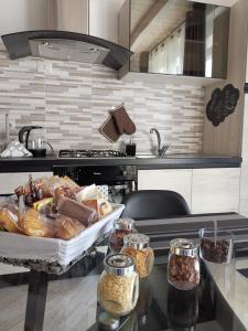 a kitchen with a counter with a tray of food at Paradeisos Residence Sas in Somma Lombardo