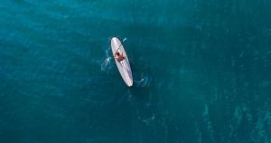 a person on a surfboard in the water at Jumeirah Beach Hotel Dubai in Dubai