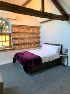 a bedroom with a bed and a brick wall at Studio 3B The Carriage House York 6m Village Location in York