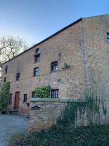 a large brick building with windows on the side of it at Studio 3B The Carriage House York 6m Village Location in York