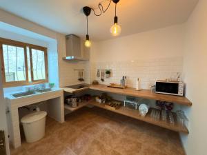 a kitchen with a counter and a microwave in it at CASA MARÍA LA ROMANA in Torres +21 photos