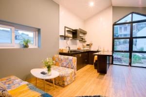a living room with a couch and a table at Kimi Uchi Home in Da Lat