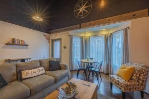 a living room with a couch and a table at Haven at Hazel ~ Downtown Studio in Demorest