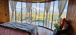 a bedroom with a large window with a view at Barichara Glamping Valley in Barichara
