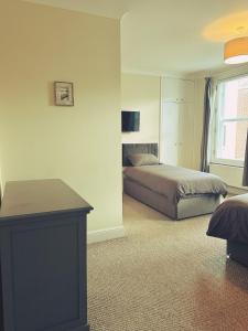 a bedroom with two beds and a table in it at Castle View, 96 Friar Lane in Nottingham