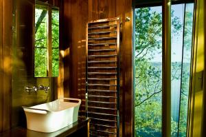 a bathroom with a sink and a large window at La Pinte du Vieux Manoir in Murten