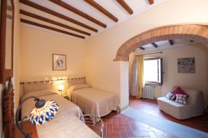 ein Schlafzimmer mit 2 Betten und einem Sofa in einem Zimmer in der Unterkunft Lungagnana Villa in Nebbiano