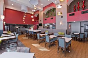 uma sala de jantar com mesas e cadeiras num restaurante em Hampton Inn & Suites Palm Desert em Palm Desert