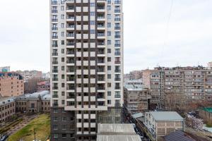 a tall white building in a city with buildings at Stay Inn apartments at Buzand 13 street in Yerevan