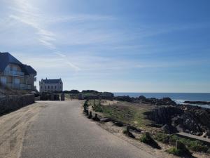 a house on the side of a road next to the ocean at Le Verdi - Les Gîtes de la Côte d'Amour in Le Croisic