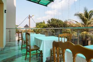 a row of tables and chairs on a balcony at CINCINNATI HOTEL YAOUNDE in Yaoundé