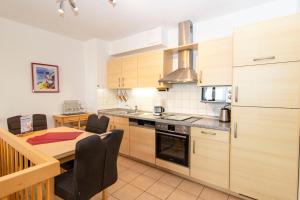 a kitchen with a table and a dining room at Nordseeblick 5 in Cuxhaven