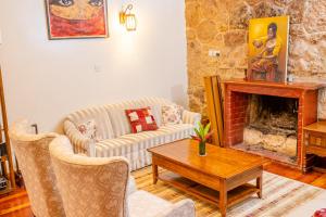 a living room with a couch and a fireplace at Zereniti House in Muyaka