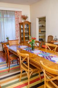 uma sala de jantar com uma mesa de madeira e cadeiras em Zereniti House em Muyaka