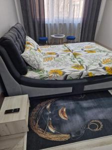 a bed sitting in a room with a rug at Sco Studio in Galaţi