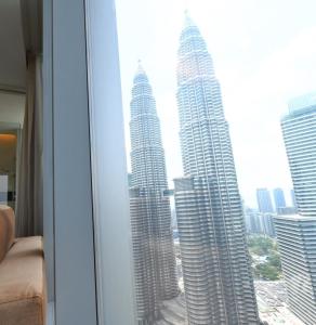 a view of the petronas twin towers from a hotel room at Tropicana The Residence KLCC in Kuala Lumpur