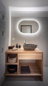 une salle de bain avec un lavabo et un miroir dans l'établissement Au Grès Des Vosges - 01, à Granges-sur-Vologne