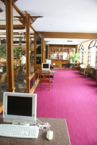 a computer sitting on a desk in a library at Royal Twins Palace Hotel in Pattaya Central