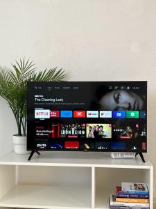 a tv sitting on top of a white shelf at Los Urrutias, Murcia, Mar Menor in Los Urrutias