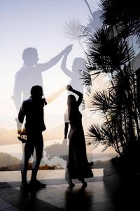 a bride and groom dancing in front of a silhouette at Best world vision in Chaweng