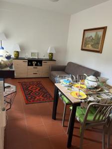 a living room with a table and a couch at Casa Elena in Manciano +21 photos