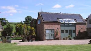 a house with solar panels on the roof at Waters Edge @ The Alleys in Atlow