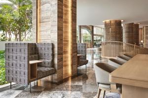 a restaurant with chairs and tables in a room at Sheraton Hai Phong in Hai Phong