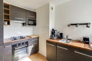 a kitchen with stainless steel appliances and wooden counters at CAEN31330 in Toulouse