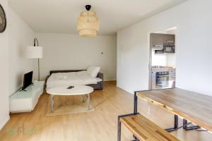 a living room with a bed and a table at CAEN31330 in Toulouse