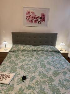 a bed with a comforter and a book on it at Casa Elena in Manciano