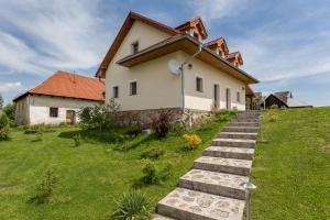 a house on a hill with some stairs in front of it at Villa Lypche in Bešeňová