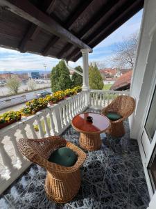 weranda ze stołem i krzesłami na balkonie w obiekcie International Inn w mieście Paraćin