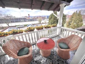 weranda z 2 krzesłami i stołem na balkonie w obiekcie International Inn w mieście Paraćin