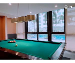 a pool table in a room with a pool ball on it at Casa de Lorille Eastwood Cozy Studio with Amazing view Free WiFi & Netflix Access in Manila