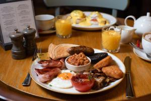 a table with two plates of breakfast food on it at The Kingslodge Inn - The Inn Collection Group in Durham +67 photos