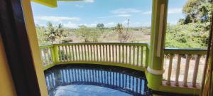 a balcony with a view of the water at Green House Stay in Mandrem