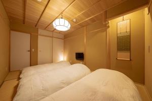 Postel nebo postele na pokoji v ubytování Saju Kyoto 茶住 京都