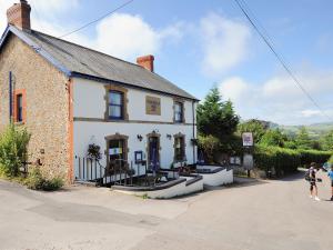 a white house with people standing outside of it at The Old Dairy in Bridport