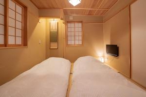 Postel nebo postele na pokoji v ubytování Saju Kyoto 茶住 京都