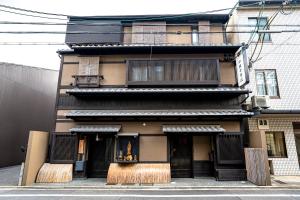 a building with a woman sitting in a window at Saju Kyoto 茶住 京都 in Kyoto