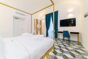 Łóżko lub łóżka w pokoju w obiekcie Palazzo Vitagliano