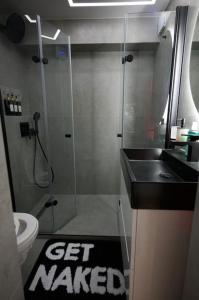 a bathroom with a shower and a sink and a toilet at BDSM apartmán v Bratislave -ADULTS ONLY in Bratislava