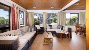a living room with a couch and a table at Nelson on Nelson in Nelson Bay