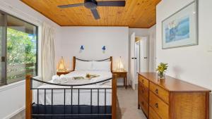 a bedroom with a bed and a wooden ceiling at Nelson on Nelson in Nelson Bay