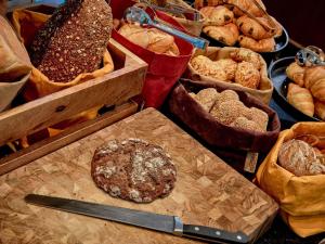 a bunch of different types of breads and pastries at 25hours Hotel Paper Island in Copenhagen