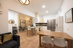 a kitchen and living room with a table and chairs at Kite & Surf Nomad House in Las Palmas de Gran Canaria