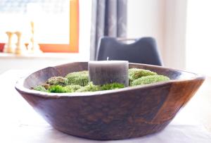a candle in a wooden bowl with moss at Fewo Nahe in Bad Sobernheim