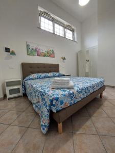 um quarto com uma cama com uma colcha em B&B La Filanda em Scilla
