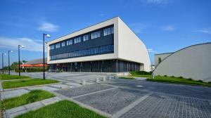 a large building with a parking lot in front of it at Hotel Bażantowo Sport in Katowice